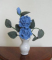 Blue roses in white vase
