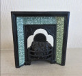 Metal fireplace with green tiles