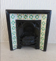 Metal fireplace with green & yellow tiles