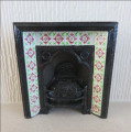 Metal fireplace with red and green tiles